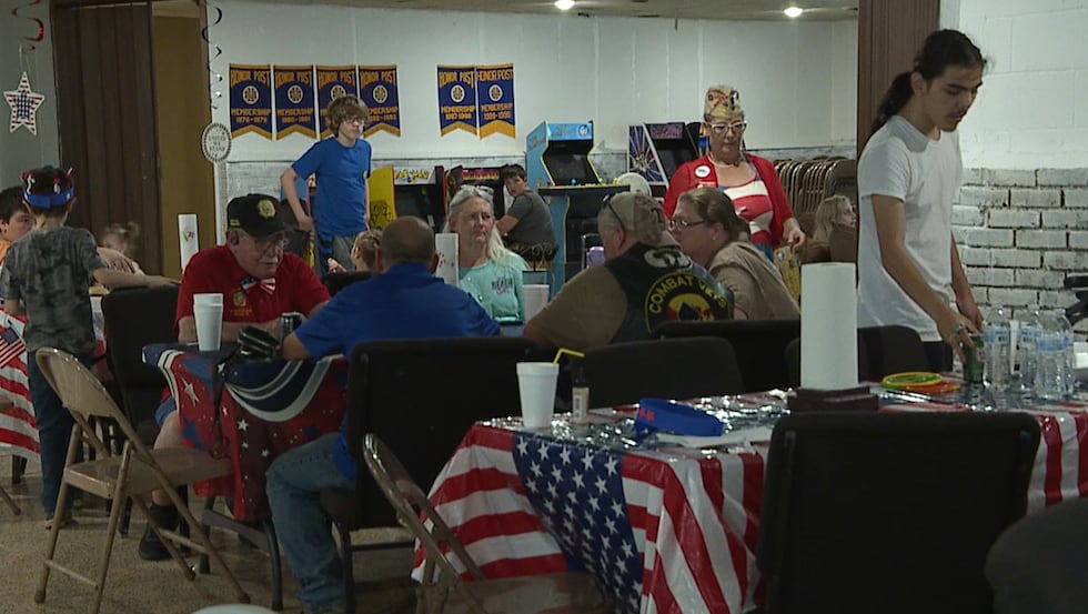 Members and guest enjoy a BBQ meal at the July 4th celebration.